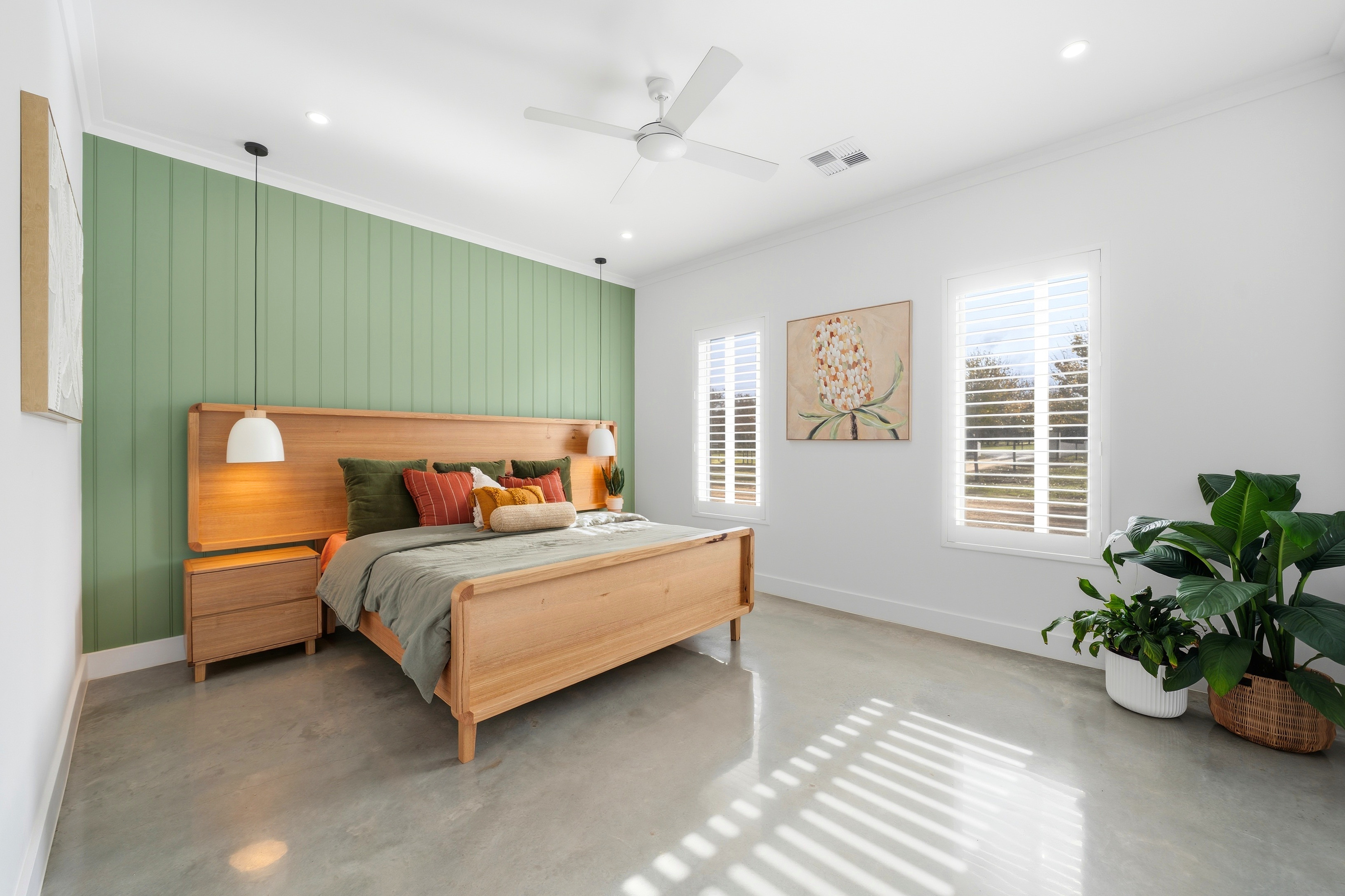 Guest bedroom with feature timber-panelled wall