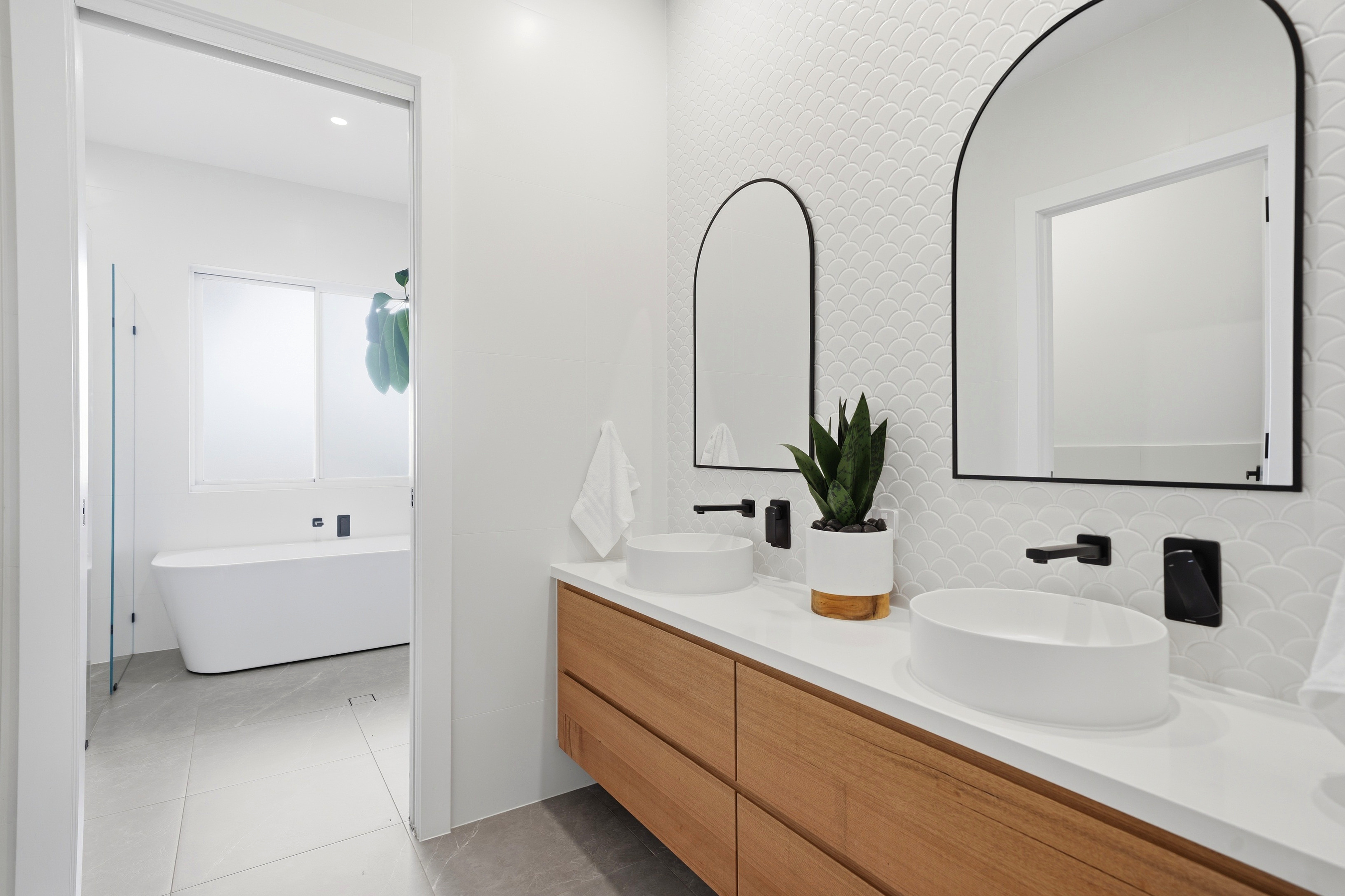 Ensuite vanity with freestanding bath beyond