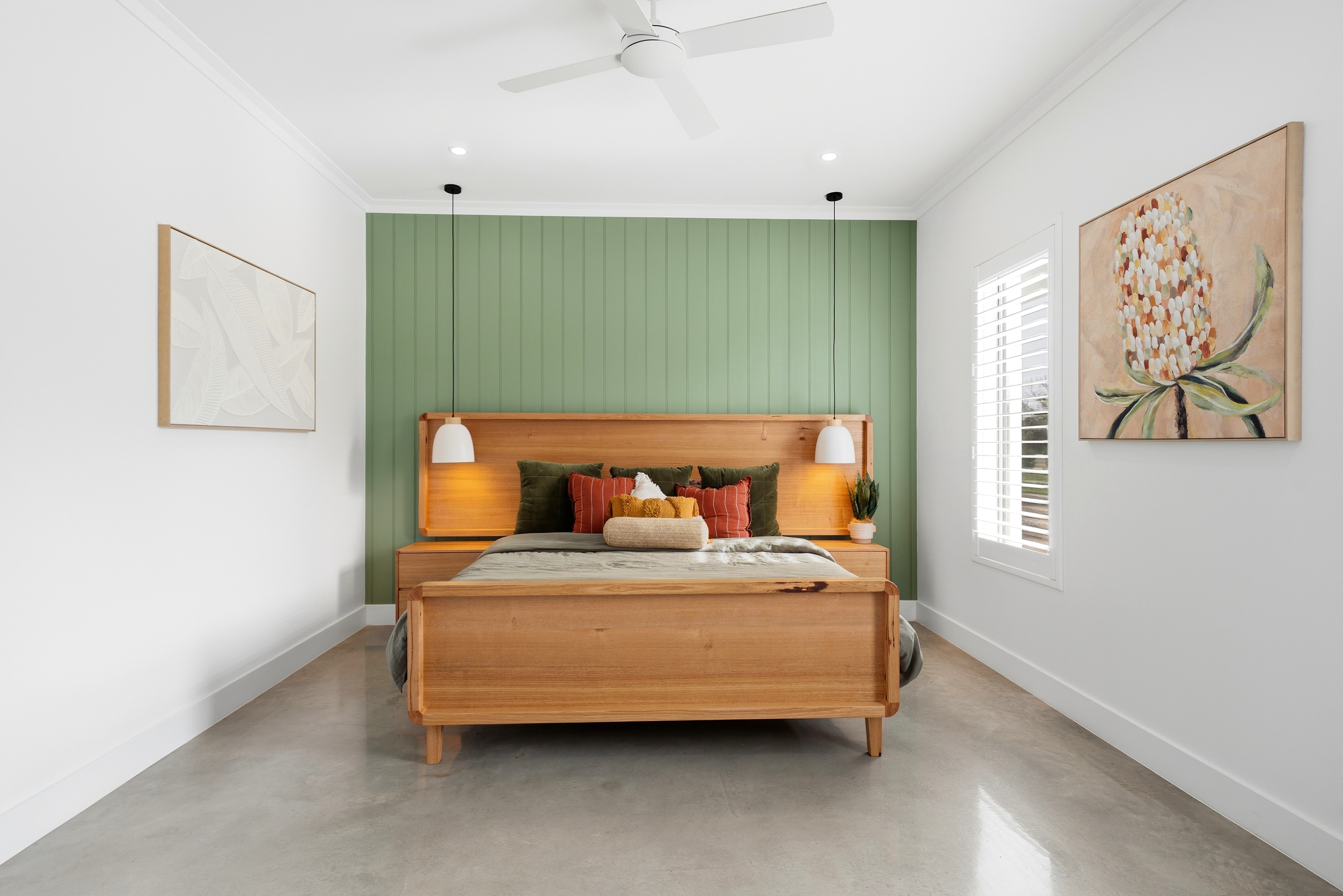 Master bedroom with sage green panelled feature wall